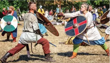  ??  ?? Cut and thrust: Members of a Viking re-enactment group go through their paces