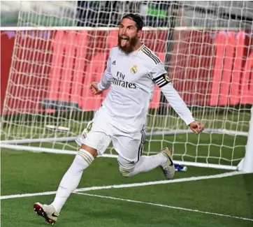  ?? (AFP) ?? Real Madrid’s Sergio Ramos celebrates after scoring against Getafe during the La Liga match in Valdebebas.