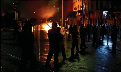  ?? ?? Riot police stands guard near the scene of the suspected stabbing, 23 November 2023. Photograph: Clodagh Kilcoyne/Reuters