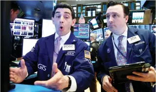  ??  ?? Traders work on the floor of the New York Stock Exchange. (Reuters)