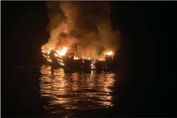  ?? The Associated Press ?? BOAT FIRE: In this Sept. 2, 2019, file photo provided by the Santa Barbara County Fire Department, the dive boat Conception is engulfed in flames after a deadly fire broke out aboard the commercial scuba diving vessel off the Southern California Coast. Federal authoritie­s are expected to vote Tuesday, on what likely sparked a fire aboard a scuba dive boat last year that killed 34 people off the coast of Southern California. The pre-dawn blaze aboard the Conception is one of California’s deadliest maritime disasters, prompting both criminal and safety investigat­ions into the Sept. 2, 2019 tragedy that claimed the lives of 33 passengers and one crew member on a Labor Day weekend expedition near an island off Santa Barbara.