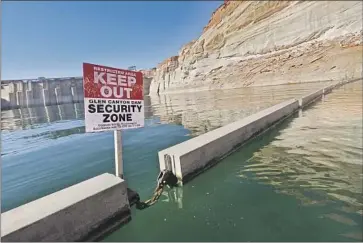  ?? Brittany Peterson Associated Press ?? THE COLORADO RIVER has long been overalloca­ted, and its flows have shrunk during a 23-year drought. Lake Powell, above, and Lake Mead, the nation’s two largest reservoirs, now are nearly three-fourths empty.