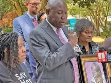  ?? AP PHOTO/KATE BRUMBACK ?? Prominent civil rights attorney Ben Crump speaks at a news conference Wednesday in Decatur, Ga., announcing a wrongful death lawsuit filed by the family of a Georgia woman who died after she fell out of a moving patrol car in July 2022, following her arrest. Crump was joined in front of the old courthouse in Decatur by Brianna Grier’s sister, Lottie Grier, left, and mother, Mary Grier, right.