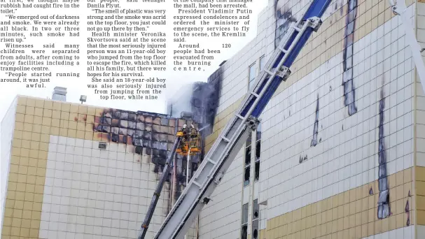  ?? Reuters photo ?? Members of the Emergency Situations Ministry work to extinguish the fire in a shopping mall. —