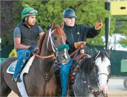  ?? JERRY JACKSON/BALTIMORE SUN ?? Trainer D. Wayne Lukas, right, figures Secret Oath, shown with exercise rider Oscar Quevedo aboard at Pimlico on Wednesday, had an easier trip in the Kentucky Oaks than Epicenter did in the Kentucky Derby, so perhaps she’ll be the fresher horse.