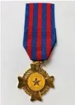  ?? ?? The Vietnam Hazardous Service Medal is a gold Maltese cross with indented arms and a silver star within a central yellow disc.