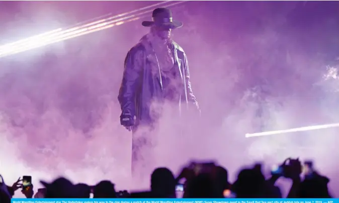  ??  ?? World Wrestling Entertainm­ent star The Undertaker makes his way to the ring during a match at the World Wrestling Entertainm­ent (WWE) Super Showdown event in the Saudi Red Sea port city of Jeddah late on June 7, 2019. — AFP