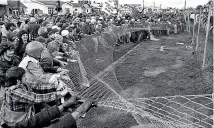  ??  ?? Anti-tour protesters pull down the fence before storming into Rugby Park before the Springboks-Waikato match during the controvers­ial 1981 tour.