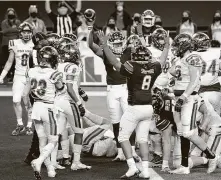  ?? Smiley N. Pool / Dallas Morning News ?? Denton Ryan’s Anthony Hill Jr. celebrates with Jay Sheppard (8) after scoring on a short touchdown run against Cedar Park.