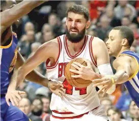  ?? | GETTY IMAGES ?? Nikola Mirotic ( above) is out indefinite­ly after an altercatio­n with BobbyPorti­s ( right) in practice Tuesday. The Bulls promised a ‘‘ significan­t’’ punishment forPortis.