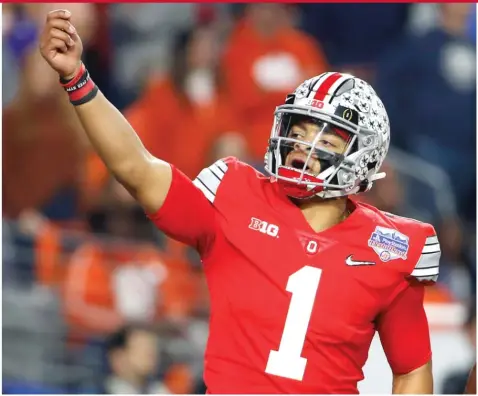  ?? GETTY IMAGES ?? Justin Fields, who was sacked nine times, learned quickly Sunday that despite playing in the state of Ohio, he wasn’t at Ohio State anymore.