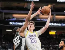  ?? Thearon W. Henderson/getty Images ?? Colin Castleton and the Lakers had a tough time getting around the Spurs’ Malaki Branham, left, during Wednesday’s game.