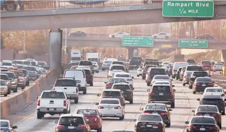  ?? DAMIAN DOVARGANES/AP ?? Cars are small, sealed spaces that make social distancing impossible and trap airborne particles that can transmit the coronaviru­s.