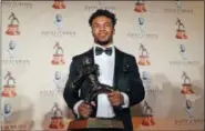  ?? LM OTERO ?? FILE - In this Feb. 18, 2019, file photo, Heisman Trophy winning quarterbac­k Kyler Murray poses with the Davey O’Brien football award, in Fort Worth, Texas. Murray’s measuremen­ts were among the most anticipate­d at this year’s NFL scouting combine after he spurned the Oakland Athletics and a career in Major League Baseball for a shot at the NFL.