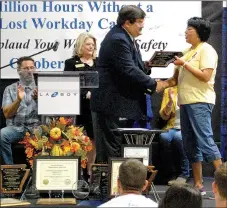  ?? Janelle Jessen/Herald-Leader ?? Ralph Hudson, deputy director of the Arkansas Department of Labor, presented La-Z-Boy employee Velma Blackfox with an award for exceeding 4 million hours worked without a lost workday during a ceremony on Thursday.