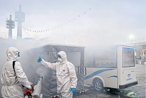  ?? REUTERS ?? Members of a medical team spray disinfecta­nt to sanitise Imam Reza’s holy shrine in Mashhad, Iran last week.