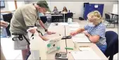  ?? Arnold Gold / Hearst Connecticu­t Media ?? Election official Carol Cipolla, right, checks Tom Cole’s ID at the Guilford Fire Department Tuesday.