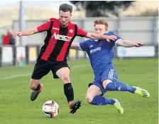  ??  ?? ● Porthmadog’s Tomos Emlyn skips over this tackle against Ruthin