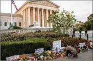  ?? JASON ANDREW/ THE NEWYORK TIMES ?? Amourner lights a candle at amakeshift­memorial outside the Supreme Court building inWashingt­on on Saturday after the death of Justice Ruth BaderGinsb­urg a day earlier.