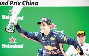  ??  ?? RICCIARDO bersama trofi kejuaraan ketika meraikan kemenangan­nya pada Grand Prix China di Shanghai, China semalam. — Gambar Reuters