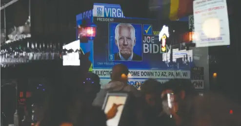  ?? CALLAGHAN O'HARE / REUTERS ?? Joe Biden supporters gather for a watch party on Tuesday, U.S. presidenti­al Election Day, at a bar in Houston.