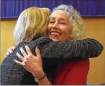  ??  ?? Newly elected Chester County Controller Margaret Reif gives newly elected Coroner Dr. Christina VandePol a hug, following their swearing-in ceremonies held at West Chester University Sykes ballroom Wednesday.