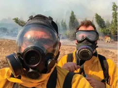  ?? Associated Press ?? ■ Associated Press photograph­er Marcio Jose Sanchez, left, takes a selfie with fellow AP photograph­er Gregory Bull while covering the Easy Fire on Wednesday in Simi Valley, Calif.