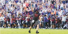  ?? BRANDON WADE/AP ?? TCU quarterbac­k Max Duggan celebrates the winning touchdown in double overtime against Oklahoma State on Saturday in Fort Worth, Texas.