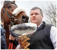  ??  ?? Distressin­g: Elliott with Morgan (left), and (above) with Grand National winner Tiger Roll in 2018. Far left, video footage shows Rob James jumping onto a dead horse