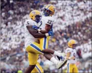  ?? BARRY REEGER — THE ASSOCIATED PRESS ?? Pittsburgh running back Vincent Davis (22) celebrates his touchdown with teammate Deslin Alexandre (5) in the first quarter of an NCAA college football game against Penn State in State College, Pa., on Saturday.