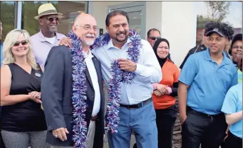  ?? / Kevin Myrick ?? Rockmart Mayor Steve Miller and Captain D’s owner Asif Jariwala celebrate together at the ribbon cutting for the new restaurant location in Polk County.