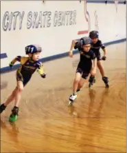  ?? NEWS-HERALD FILE ?? A trio of young skaters in the Tri-State Speed League vie for the best time during a scrimmage meet March 18 at City Skate Center in Painesvill­e.