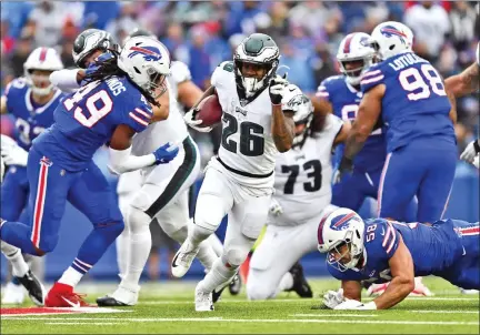  ?? ADRIAN KRAUS — THE ASSOCIATED PRESS ?? The Philadelph­ia Eagles’ Miles Sanders (26), center, breaks through the Buffalo Bills defense to score a touchdown during the second half of an NFL game, Sunday in Orchard Park, N.Y.