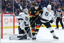  ?? DEREK CAIN — GETTY IMAGES ?? Goalie Cam Talbot and Jordan Spence of the Kings defend against Brock Boeser of the Canucks on Thursday night in Vancouver. The Kings went on to a dominating 5-1victory. For details and more on the Kings, go to