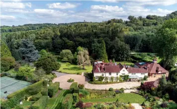  ?? ?? Above and below: Georgian The Old Rectory, Hascombe, is Grade II listed, with impressive interiors and landscaped grounds. £8.5m