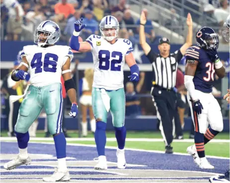  ?? | AP ?? Bears safety Adrian Amos seemingly has no interest in watching Alfred Morris ( 46) and Jason Witten whoop it up after Morris’ touchdown.