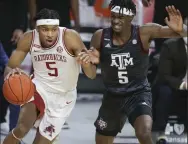  ?? (NWA Democrat-Gazette/Charlie Kaijo) ?? Arkansas guard Moses Moody (left) drives the ball as Texas A&M forward Emanuel Miller defends during the first half Saturday at Walton Arena in Fayettevil­le. Moody scored 28 points to lead the Razorbacks to an 87-80 victory. More photos at arkansason­line. com/37tamua/