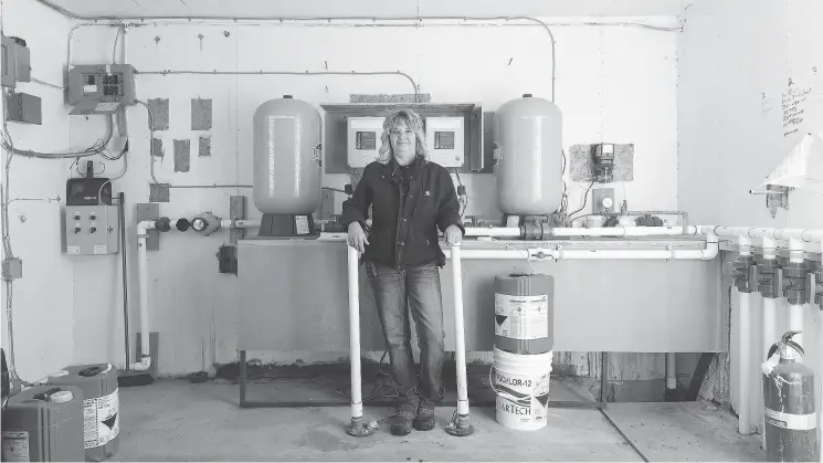  ?? QC PHOTO BY MICHAEL BELL ?? Chris Bauck, the Mayor of Ernfold, stands in the community’s water treatment facility.