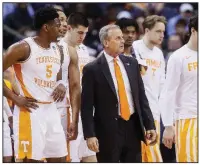  ?? AP/JOHN MINCHILLO ?? Tennessee Coach Rick Barnes (center right) meets with his players in the first half of the Volunteers’ 83-77 overtime victory over Iowa in the second round of the NCAA Tournament.