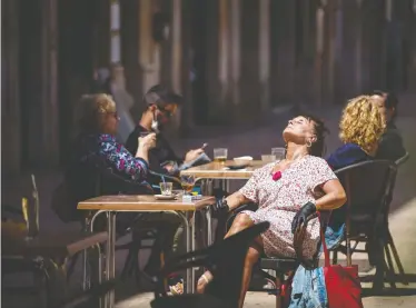  ?? EMILIO MORENATTI/THE ASSOCIATED PRESS ?? Customers sit and drink on a terrace bar in Tarragona, Spain, on Monday, as about half of the hard-hit nation of 47 million people transition­s to a softer version of the country’s rules of strict confinemen­t.