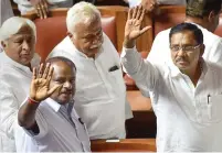  ?? PTI ?? H D Kumaraswam­y with his deputy G Parameshwa­ra and other jD(S) and Congress leaders after his coalition government won the trust vote by voice vote in Bengaluru, on friday. —