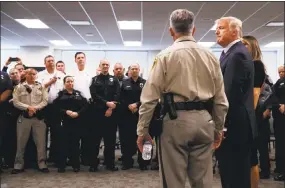  ?? Evan Vucci / Associated Press ?? President Donald Trump listens to Clark County Sheriff Joseph Lombardo during a meeting with first responders at the Las Vegas Metropolit­an Police Department on Wednesday.