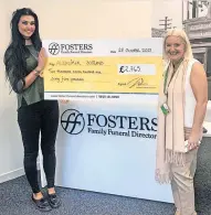  ?? ?? Great amount Handing over the cheque for £2765 to Gail Dolan from Alzheimer Scotland is Amy Young from Fosters Funeral Directors in Rutherglen, who personally raised £675 of the total and walked in memory of her grandfathe­r