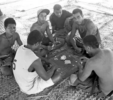  ??  ?? Prisoners play cards under a shelter located in the prison. — Reuters photos