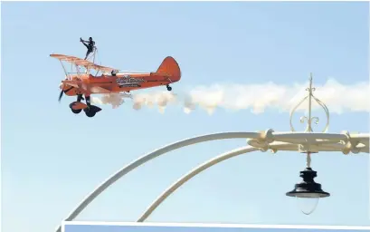  ?? The Bristol Blenheim in flight, above left; Aerosuperb­atics Wingwalker­s flying over the Pier, above; and, right, the Lancaster bomber banks over the beach ??