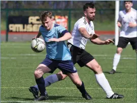  ?? ?? Town’s Brendan Lilley gets away from Athletic’s Daniel Goan. Photo by Donnie Phair.