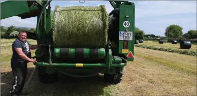  ?? Photo by Domnick Walsh ?? Brian Denny from Killorglin manning the baler during silage cutting outside Milltown last week.