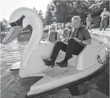  ?? Jason Fochtman / Staff photograph­er ?? J.J. Hollie, president of The Woodlands Area Chamber of Commerce, takes a swan boat out for a spin with Ann Snyder, a member of The Woodlands Township board of directors.