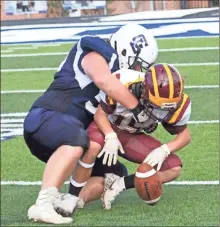  ?? Scott Herpst ?? Gordon Lee’s Griffin Moore crunches a Dade player and forces a fumble on a kickoff return during the Trojans’ 38-0 victory in Chickamaug­a this past Thursday.