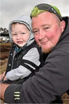  ??  ?? Three-year-old Axle Boyd and dad Adrian Boyd travelled from Logan to watch the tractor pull action.